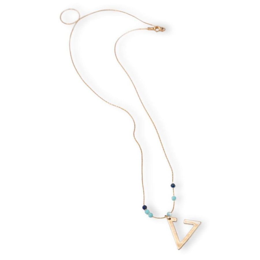 A gold necklace with a triangle pendant and a Lapis and an Amazonite.